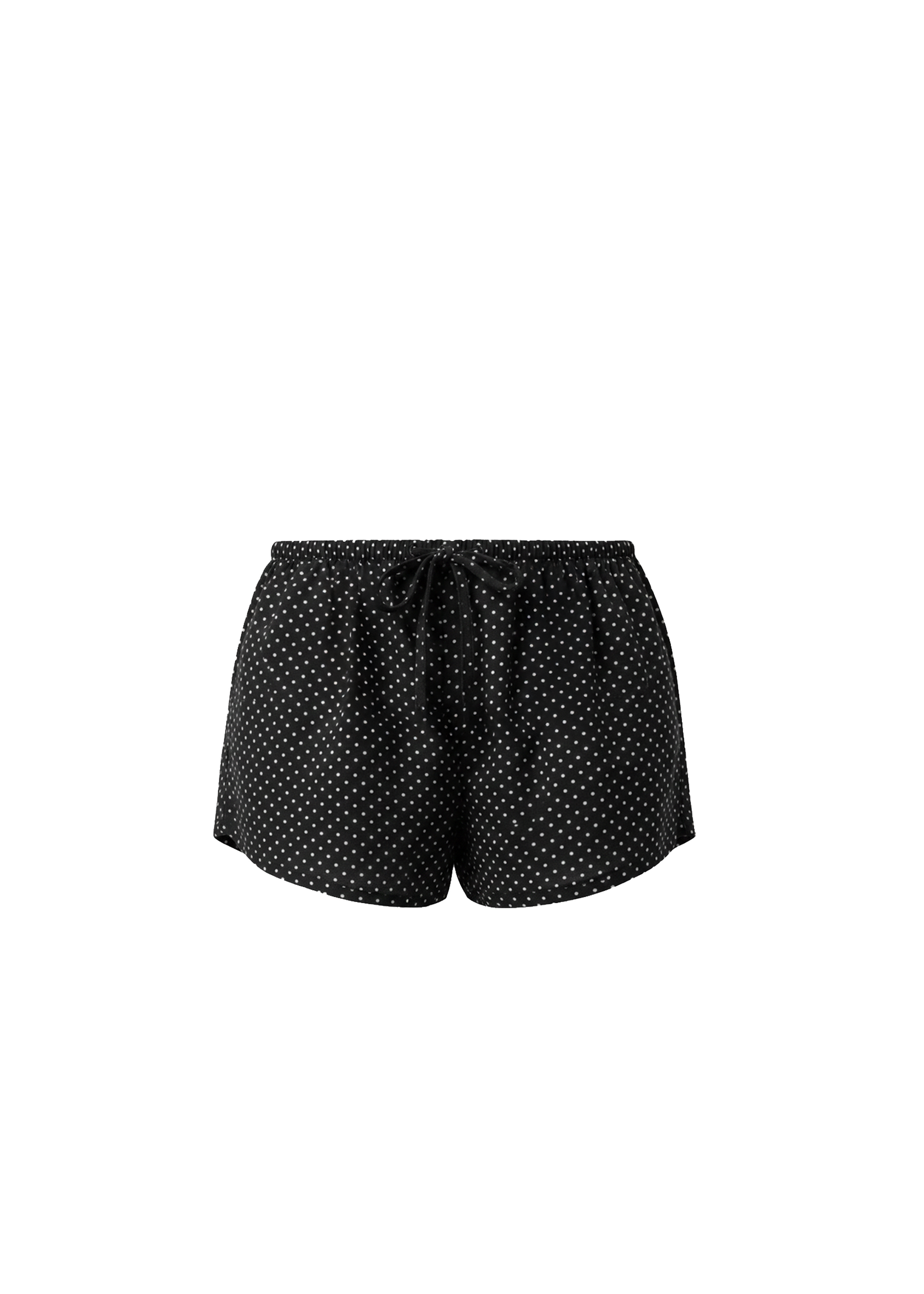 Black polka dot shorts on a white background